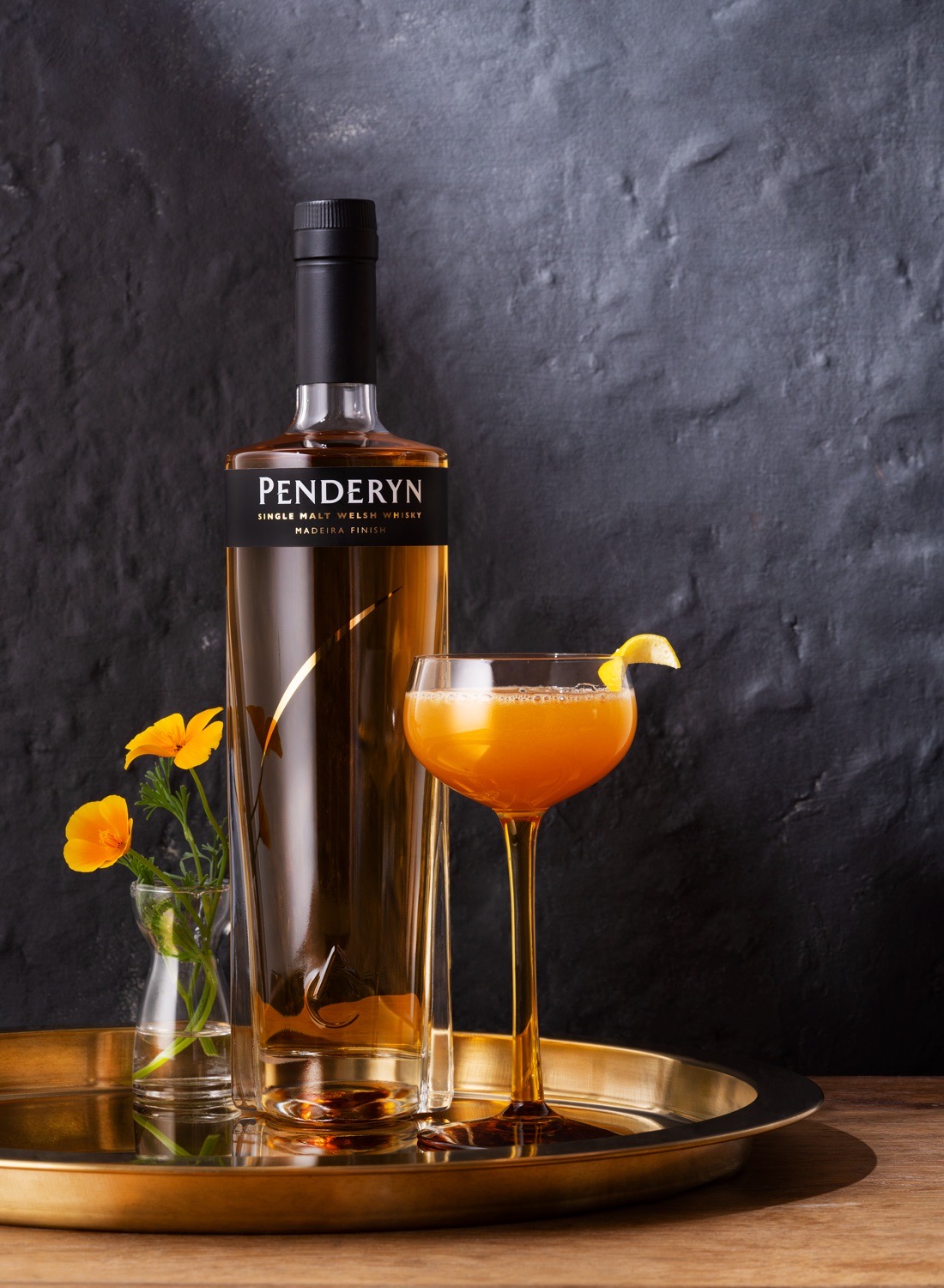 Penderyn Madeira Whisky bottle next to a cocktail glass filled with the Welsh Gold cocktail