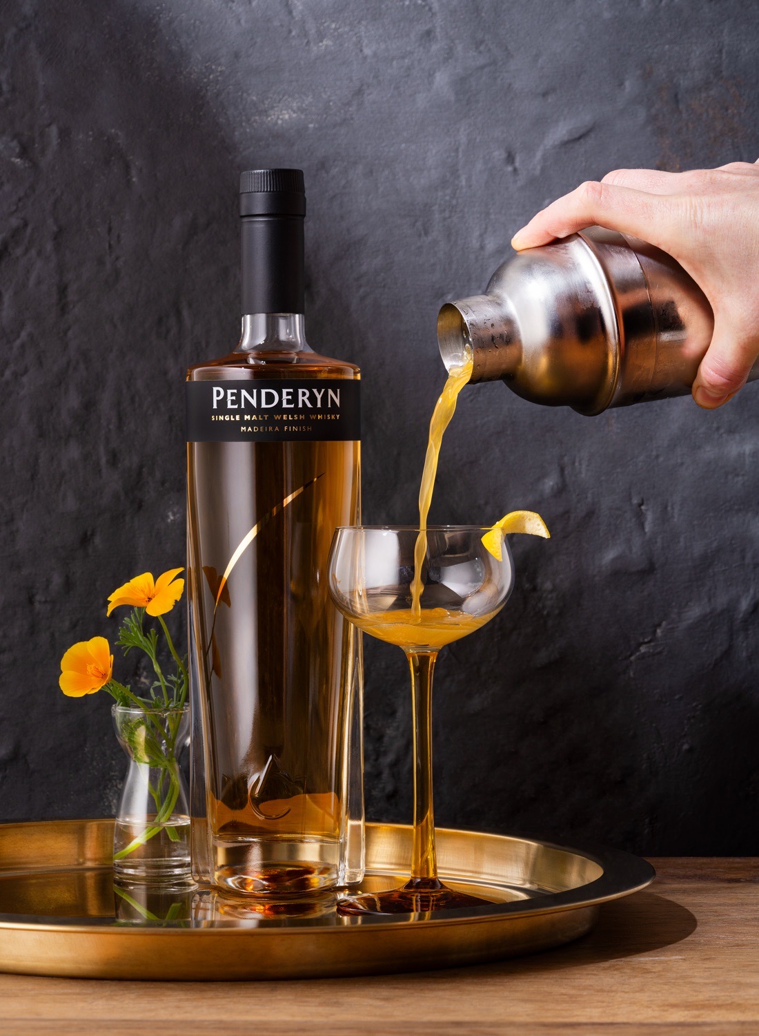 Penderyn Cocktail Welsh Gold being poured into a tall cocktail glass